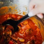 Slow cooker full of a bubbling winter stew on a home kitchen counter