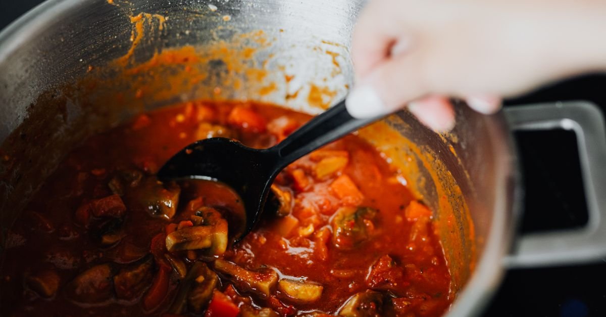 Slow cooker full of a bubbling winter stew on a home kitchen counter
