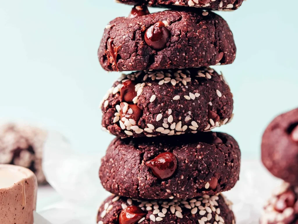 Stack of fudgy chocolate tahini cookies with molten chips