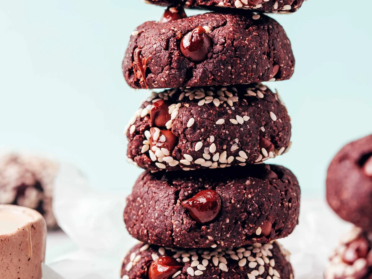 Stack of fudgy chocolate tahini cookies with molten chips