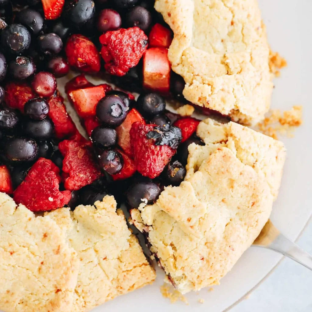 Finished almond flour berry galette with fresh berries on a golden crust