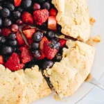 Finished almond flour berry galette with fresh berries on a golden crust