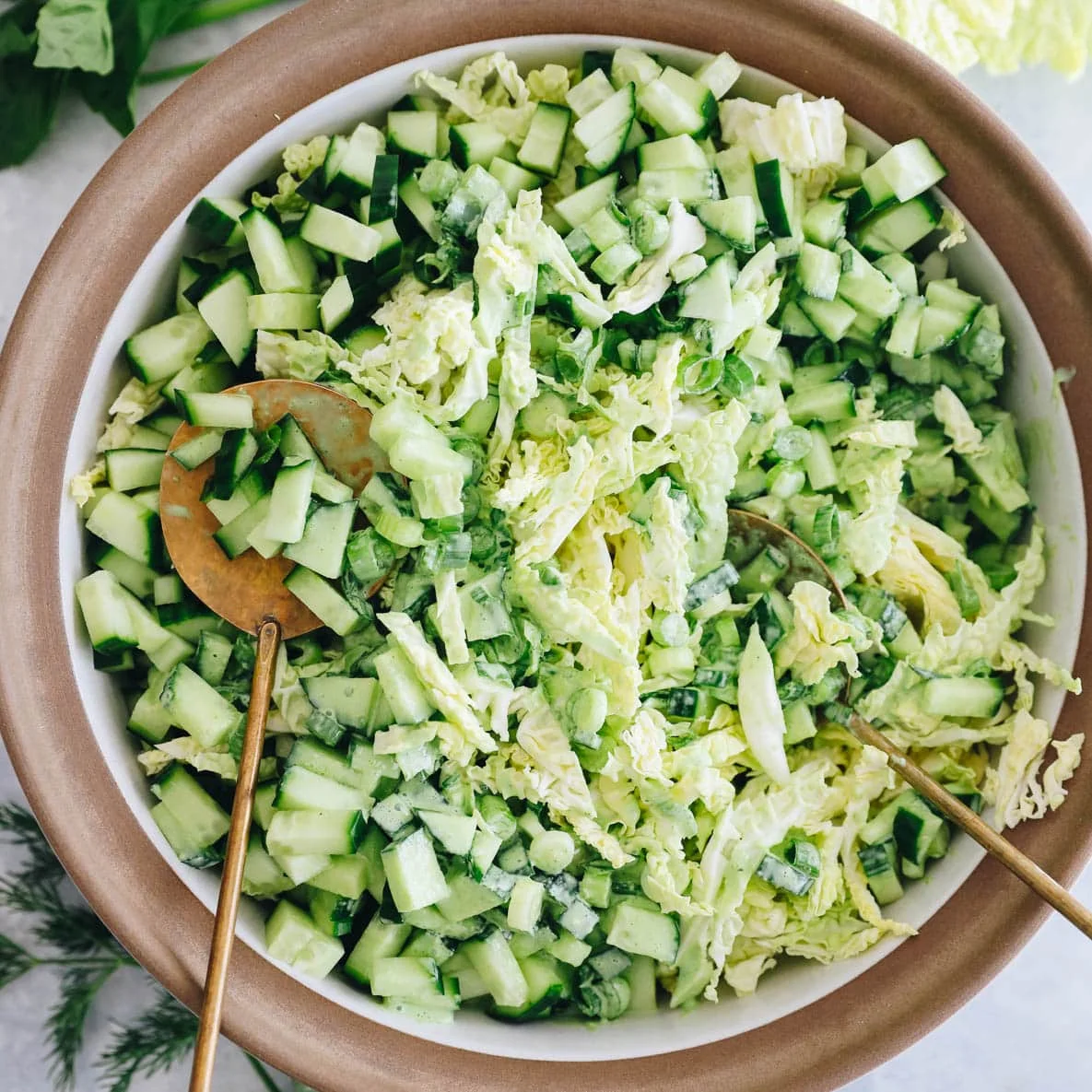 Green goddess salad with chopped cucumber and shredded cabbage