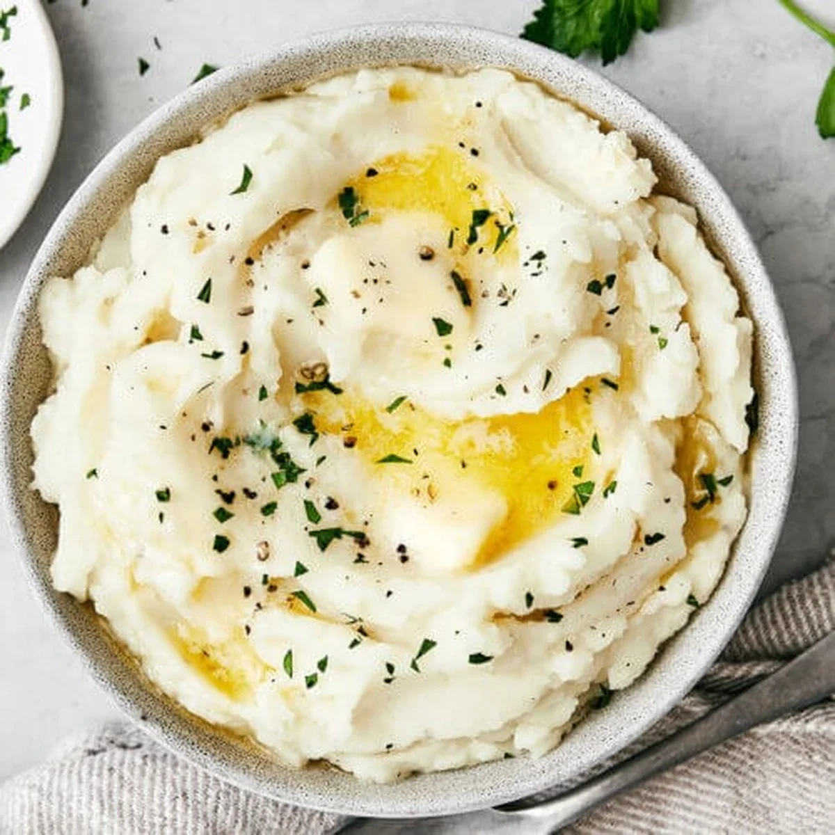 Creamy mashed potatoes topped with melted butter and chives