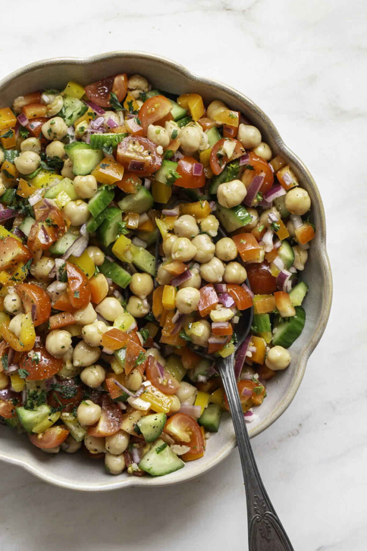 Diced vegetables and chickpeas mixed in a large bowl