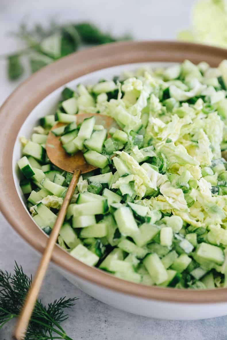 Close-up of finished green goddess salad in ceramic bowl