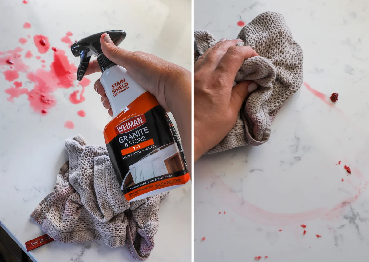 Stone countertop being wiped clean of cherry juice stains