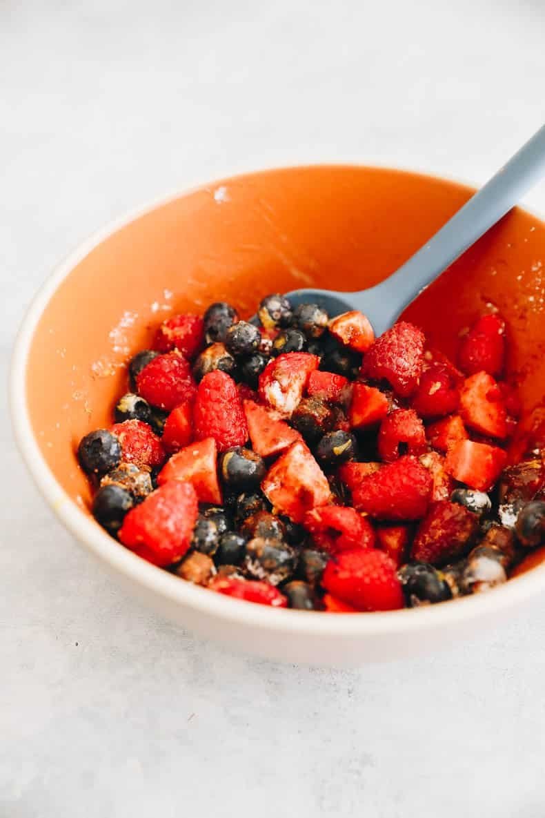 Bowl of mixed fresh berries with a spoon, ready for the filling