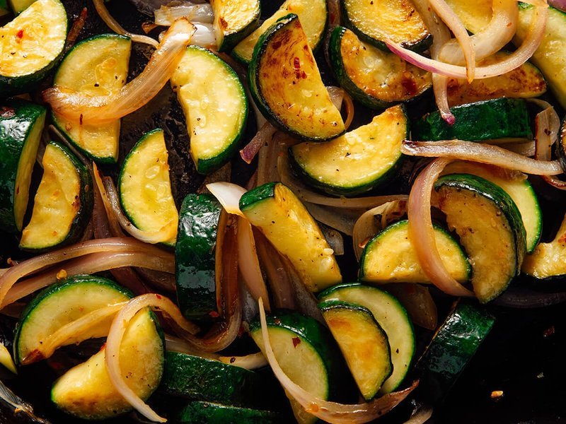Zucchini browning in a cast iron skillet