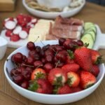 Assorted appetizers laid out for summer entertaining on a picnic table