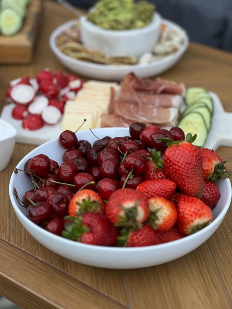 Assorted appetizers laid out for summer entertaining on a picnic table