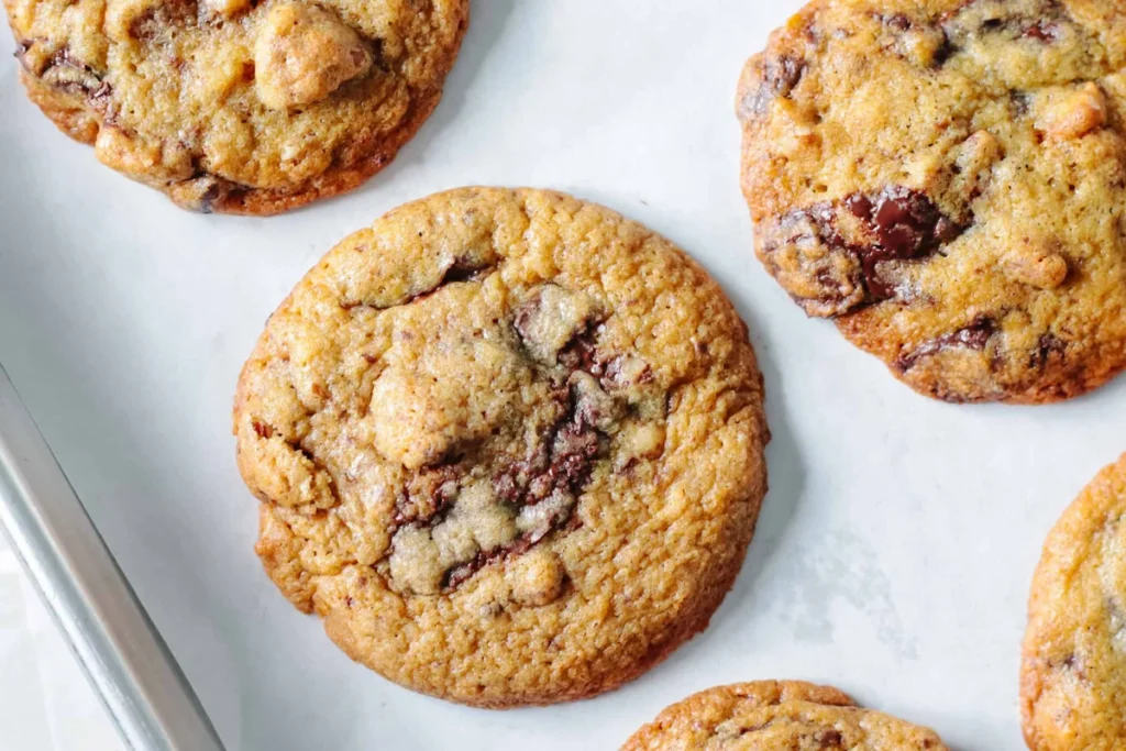 Stack of chocolate chunk pecan cookies with cracked tops