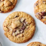 Stack of chocolate chunk pecan cookies with cracked tops