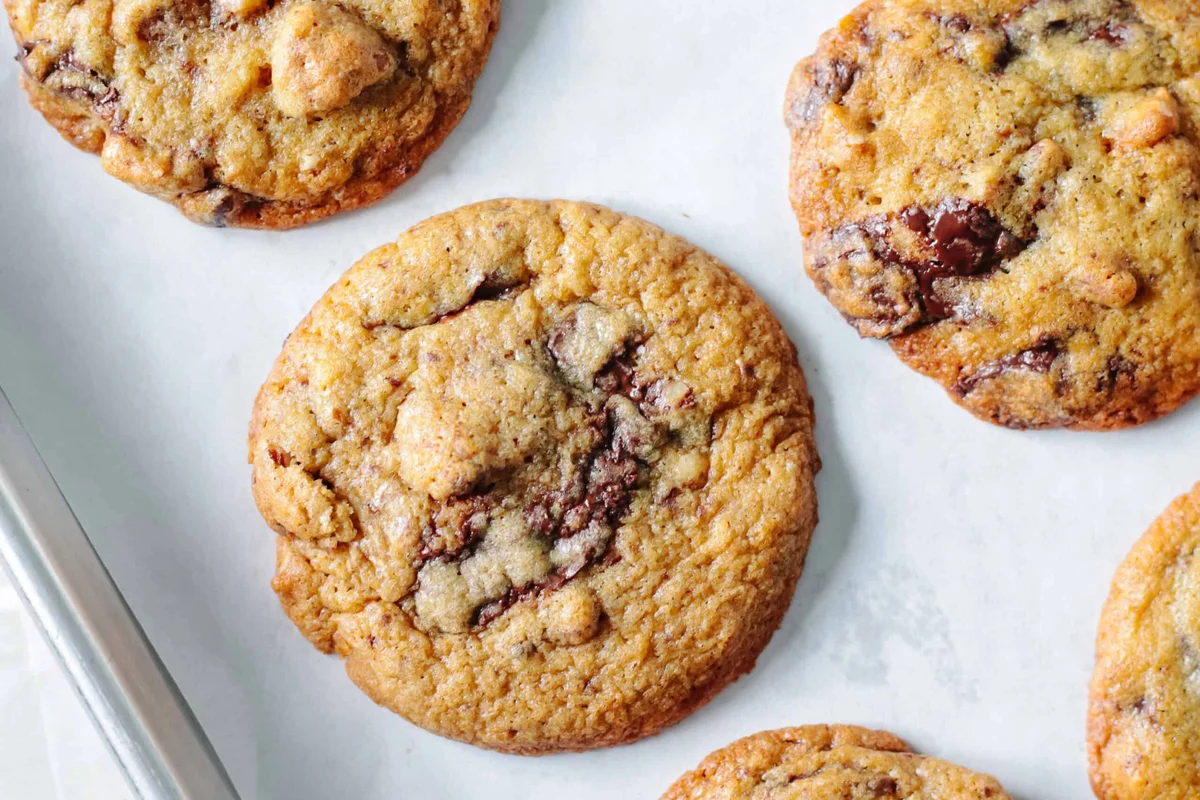 Stack of chocolate chunk pecan cookies with cracked tops