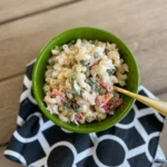 Creamy tuna pasta salad in a green bowl with a spoon