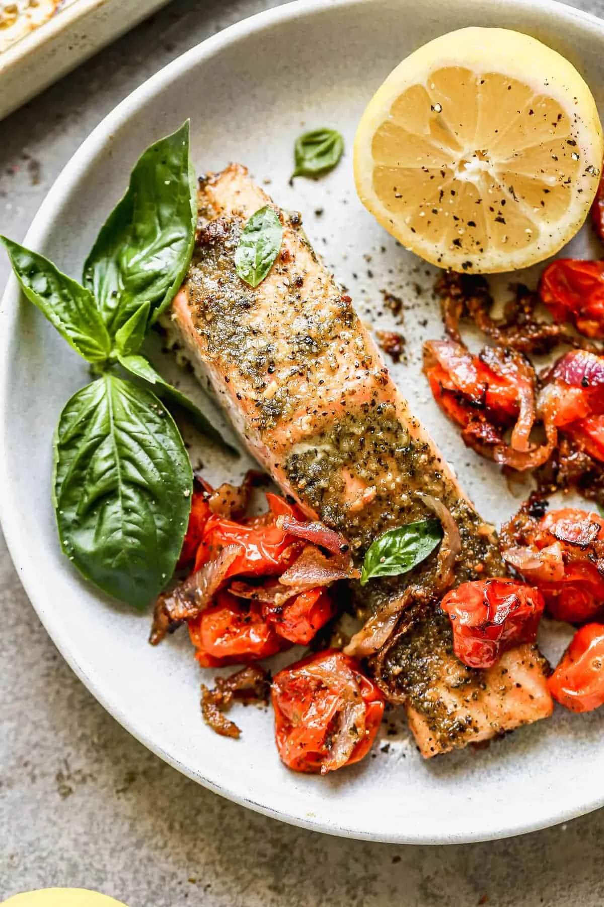 Sheet pan pesto salmon with fresh basil on top