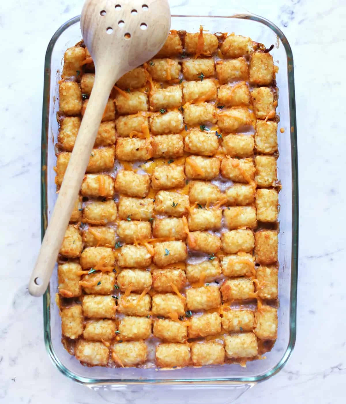Golden baked tater tot casserole in a 9x13 dish