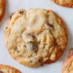 Freshly baked Ritz-Carlton-style chocolate chip cookies on parchment paper