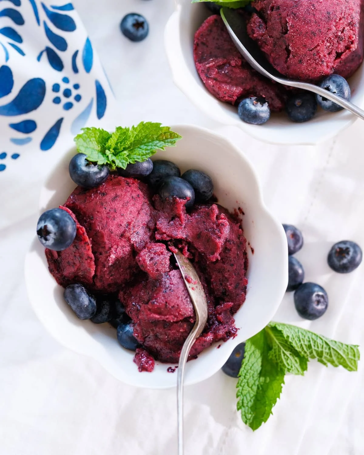 Fresh blueberries spread on a sheet pan ready to freeze