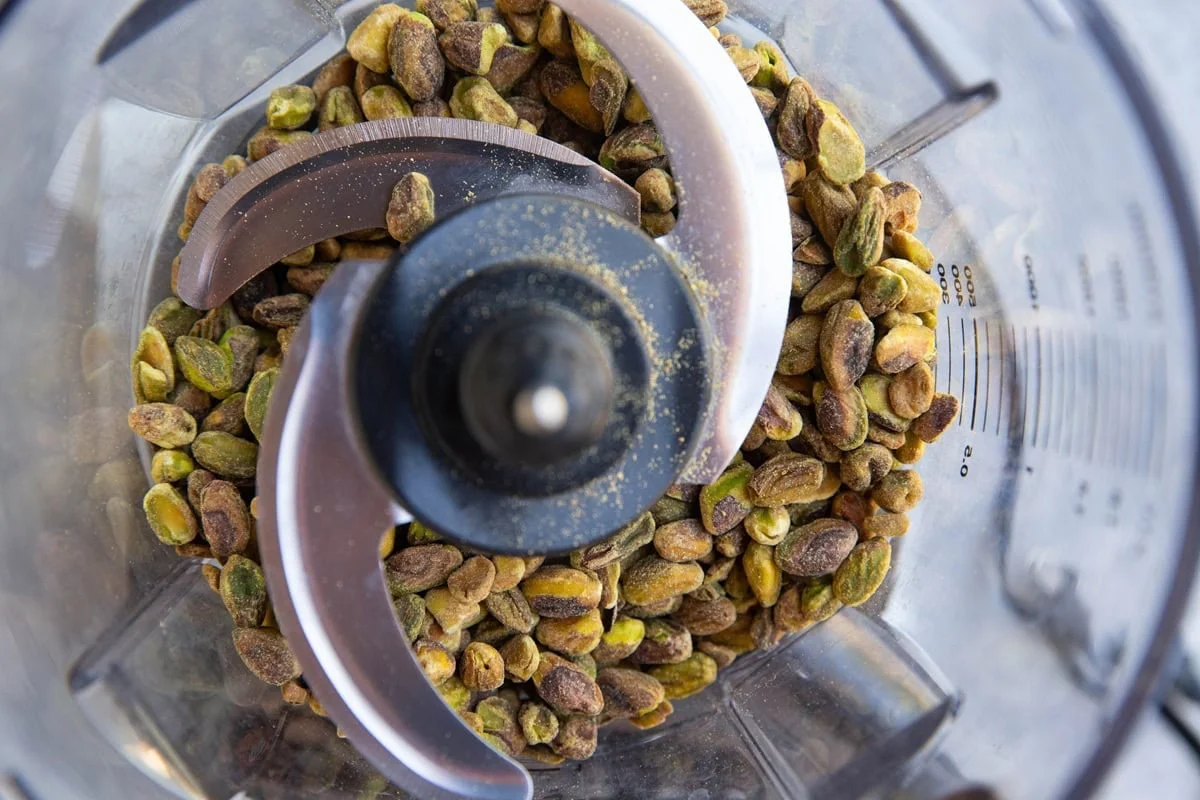 Shelled pistachios in a food processor ready to grind
