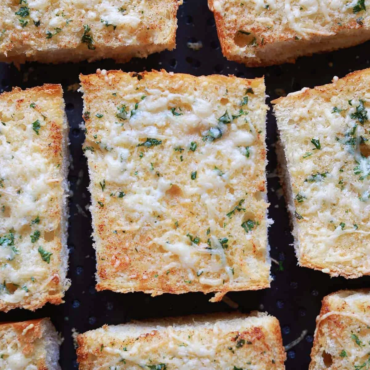 Garlic toast cooling on a plate after baking