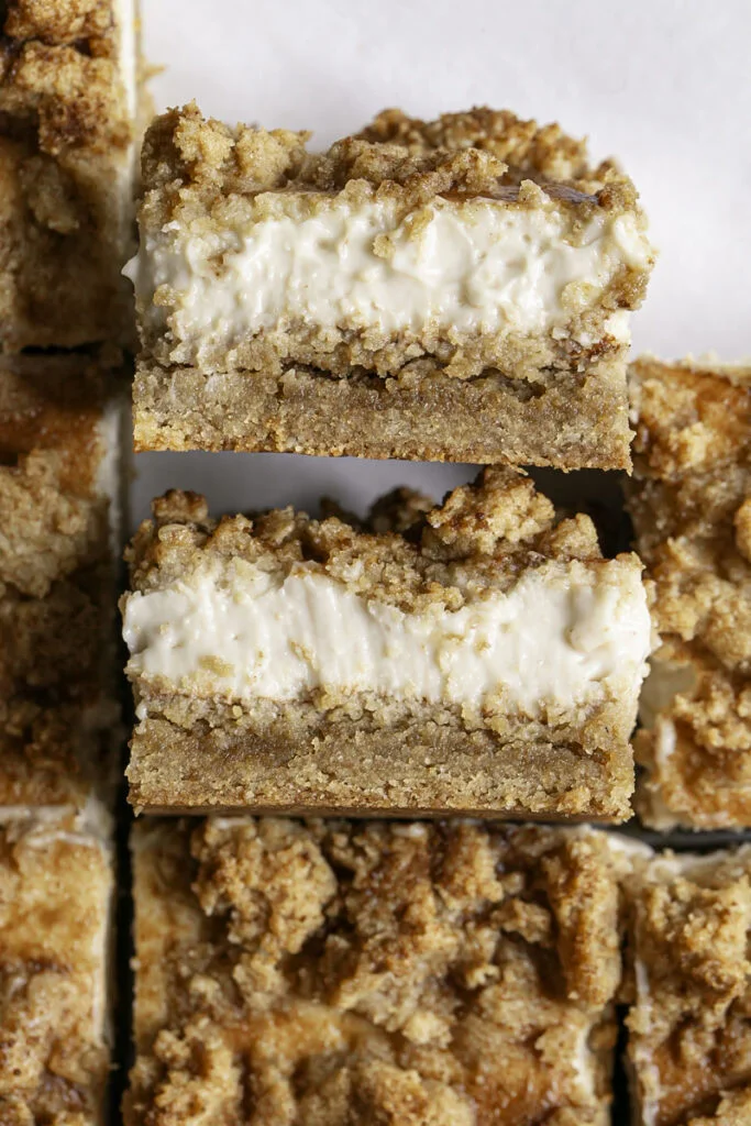 Pan of vegan cinnamon cookie cheesecake crumb bars on parchment