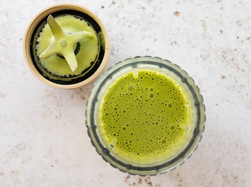 Blender jar filled with freshly blended green goddess salad dressing