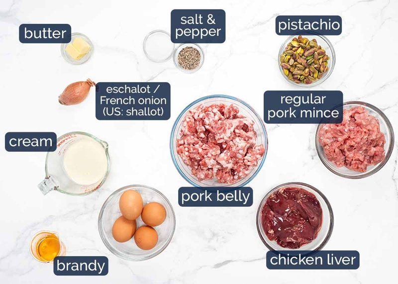 Labeled terrine ingredients arranged on a white marble counter