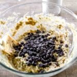 Chocolate chips folded into thick zucchini bread batter