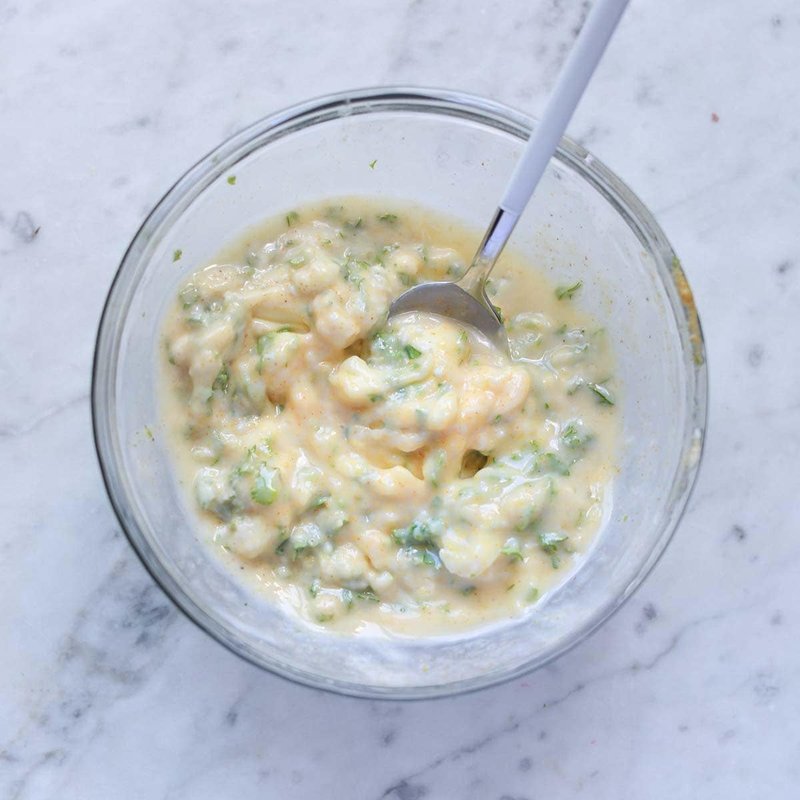 Bowl of garlic butter mixture ready to spread on bread