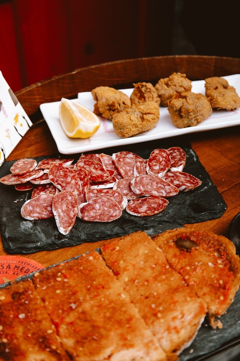 Assorted tapas of croquettes and sliced cured sausage ready to share