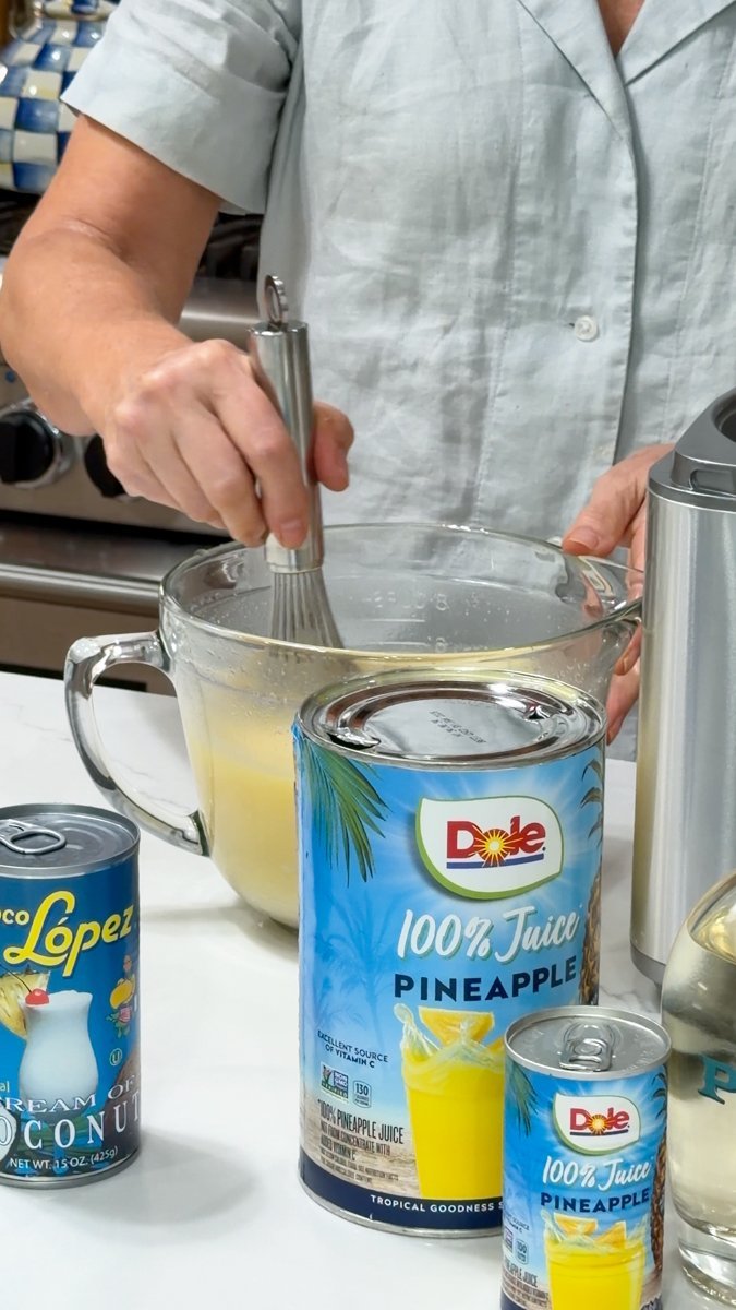 Pineapple coconut cocktail base being whisked in glass bowl