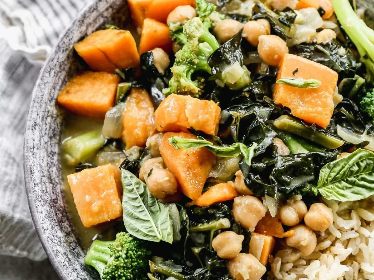 Green chickpea curry topped with fresh basil leaves
