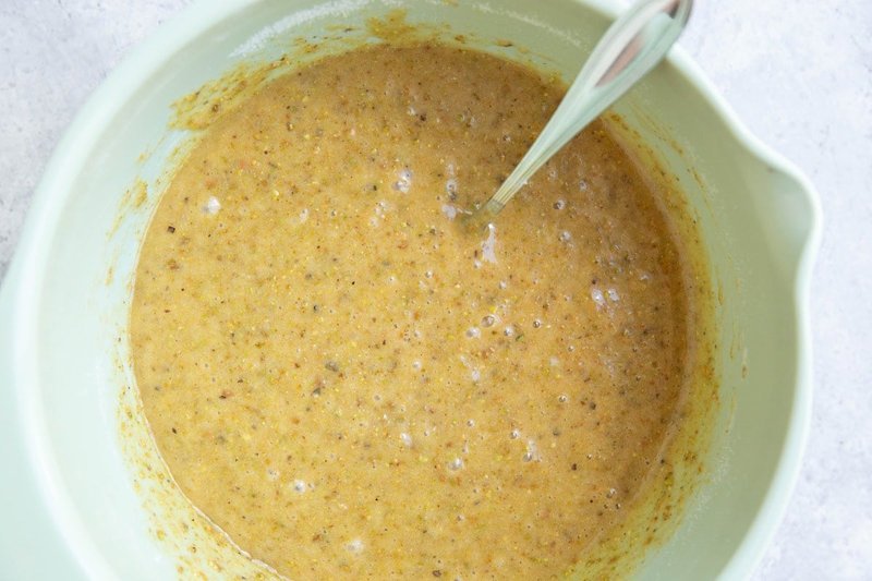 Smooth pistachio cake batter mixed in a bowl
