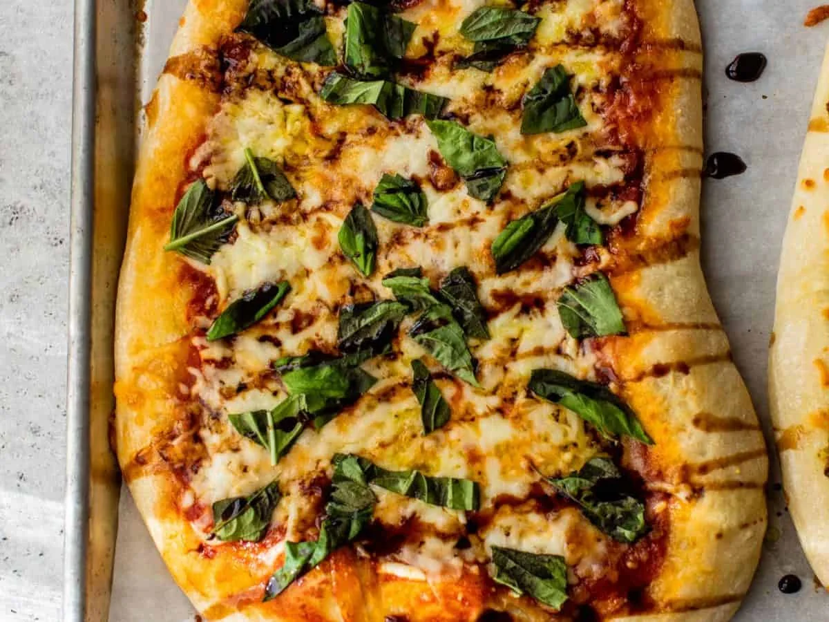 Flatbread pizza topped with fresh basil leaves