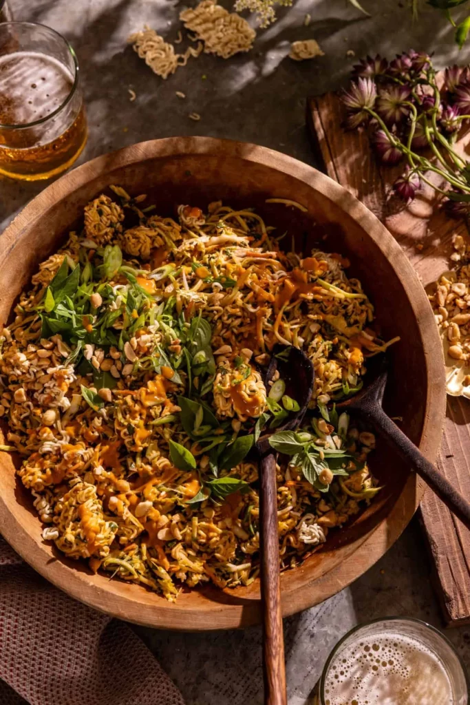 Bowl of crunchy peanut chicken ramen salad with peanuts and herbs