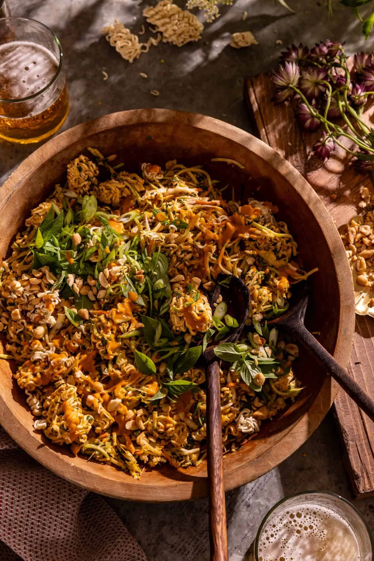 Bowl of crunchy peanut chicken ramen salad with peanuts and herbs