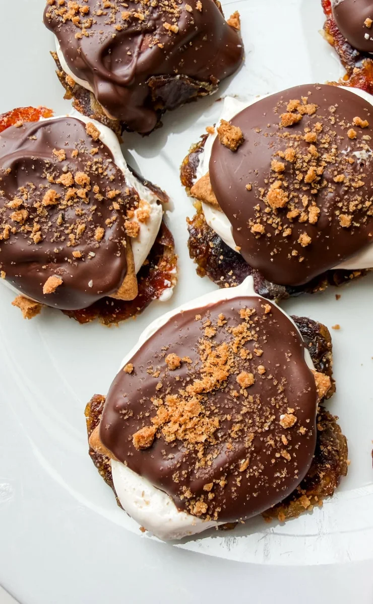 Top-down view of smashed date s'mores with chocolate drizzle