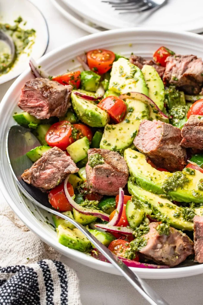 Chopped chimichurri steak salad with avocado and fresh herbs