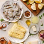Pan of shrimp scampi with garlic lemon butter sauce over linguine