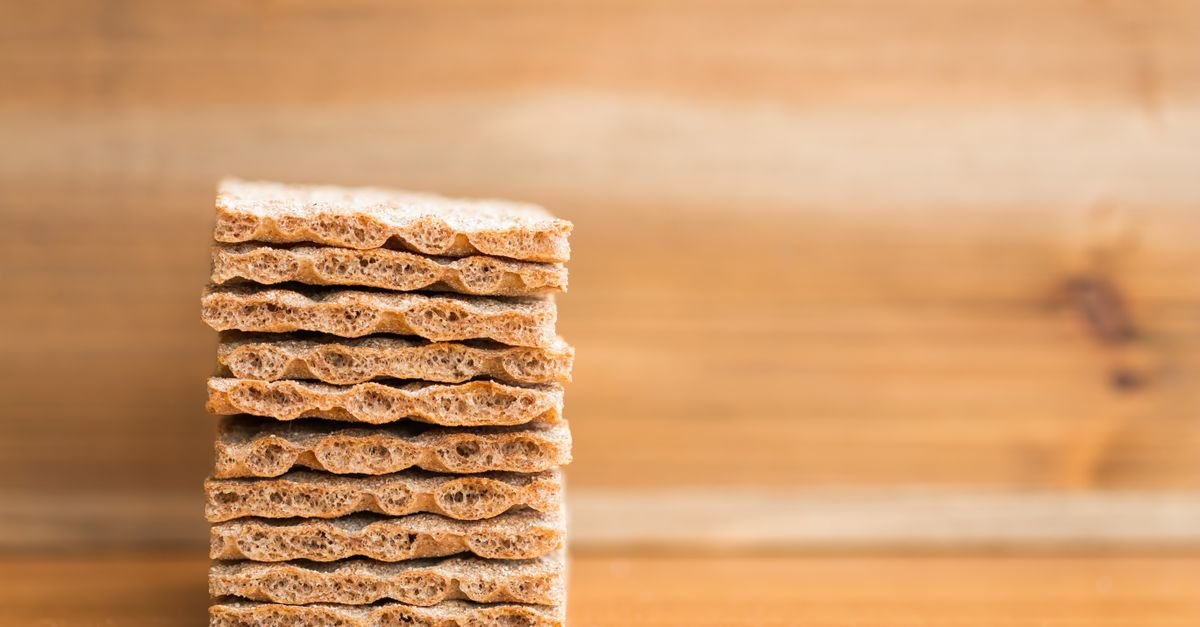 Stack of crisp whole-grain graham-style crackers on a wooden table