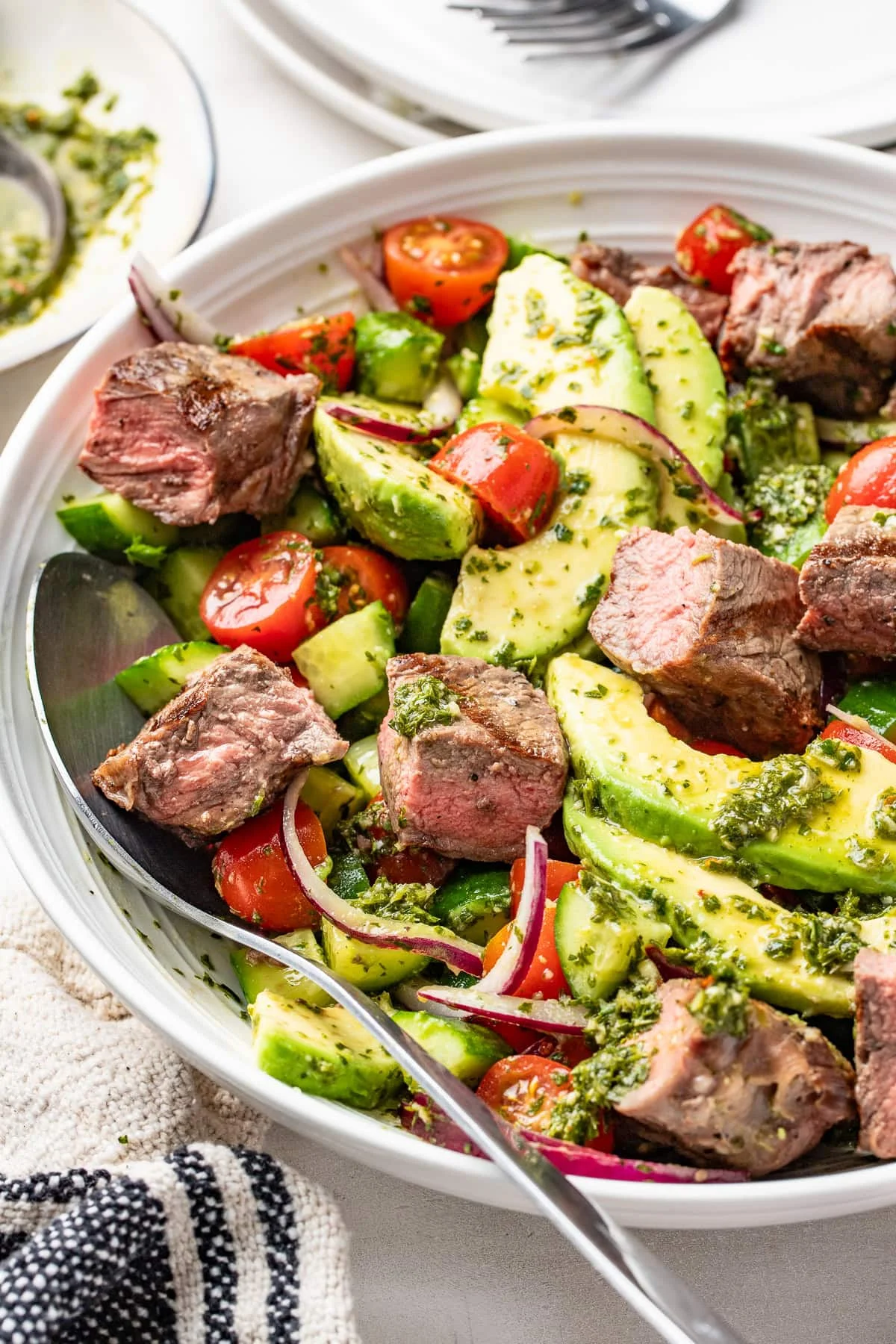 Chopped chimichurri steak salad with avocado and fresh herbs