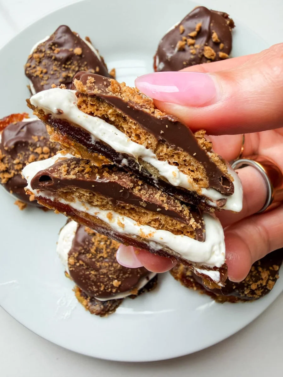 Broken smashed date s'more showing layered marshmallow and cracker