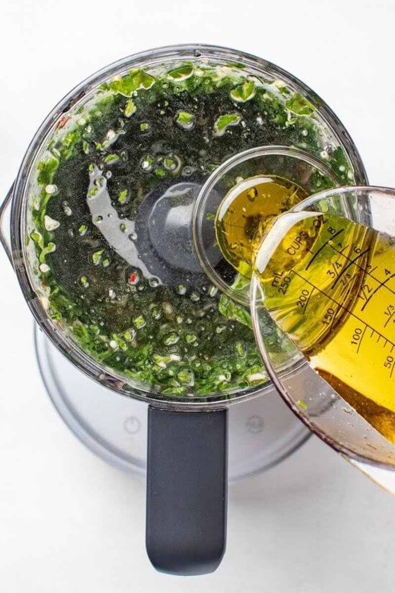 Chimichurri dressing being blended in a food processor