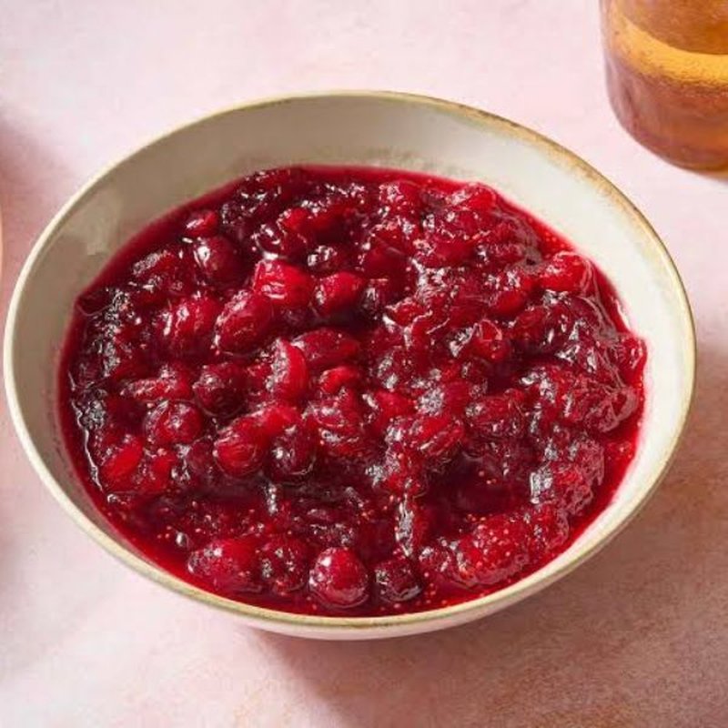 Glossy cranberry sauce in a white bowl